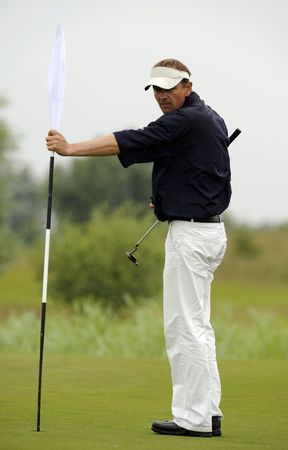 Golfer remove a hole flag before final shot の写真素材