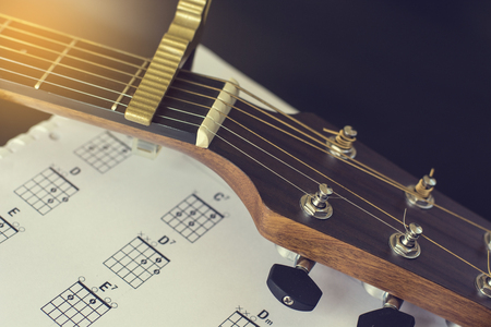 Headstock with capo of acoustic guitar and basic chord.の写真素材