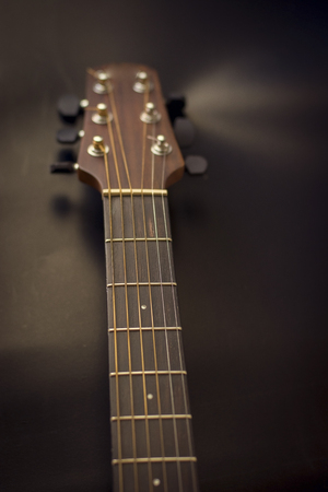 Headstock,fret bord,frets,tuners of guitar acoustic.