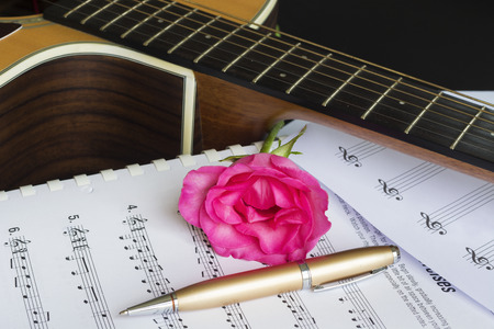 Guitar with pen and rose on the note book,vintage filterの写真素材