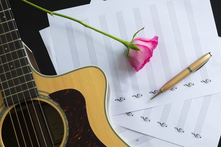 Guitar with pen and rose on the note book,vintage filterの写真素材