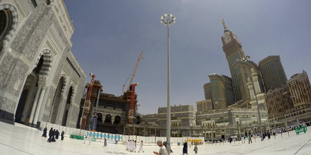 MECCA, SAUDI ARABIA, 13 April 2017 - The view of pedestrians heading to the Haram Mosque in Mecca and Mecca Royal Clock Tower Hotel.のeditorial素材