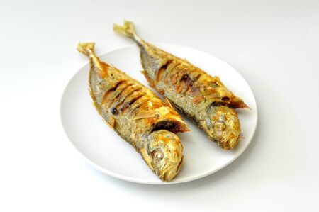 yellow scad fry fish isolated white backgroundの写真素材