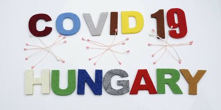 CONCEPT COVID-19 PENDAMIC  The coronavirus COVID-19 is affecting 210 countries include Hungary. White background and some blur effect. Colourful felt Text .の写真素材