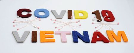 CONCEPT COVID-19 PENDAMIC  The coronavirus COVID-19 is affecting 210 countries include Vietnam. White background and some blur effect. Colourful felt Text .の写真素材