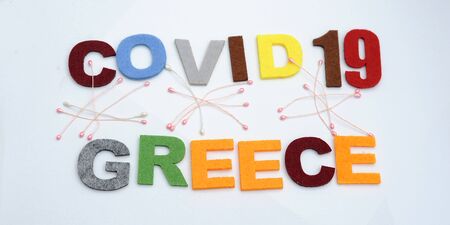 CONCEPT COVID-19 PENDAMIC  The coronavirus COVID-19 is affecting 210 countries include Greece. White background and some blur effect. Colourful felt Text .の写真素材