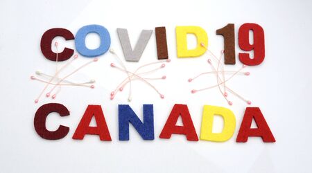 CONCEPT COVID-19 PENDAMIC  The coronavirus COVID-19 is affecting 210 countries include Canada. White background and some blur effect. Colourful felt Text .の写真素材