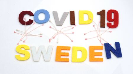 CONCEPT COVID-19 PENDAMIC  The coronavirus COVID-19 is affecting 210 countries include Sweden. White background and some blur effect. Colourful felt Text .の写真素材