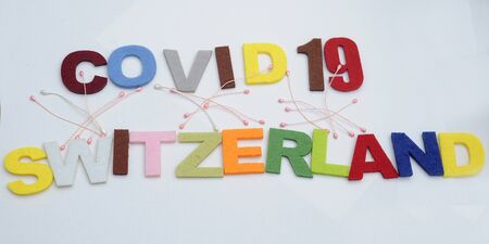 CONCEPT COVID-19 PENDAMIC  The coronavirus COVID-19 is affecting 210 countries include Switzerland. White background and some blur effect. Colourful felt Text .の写真素材