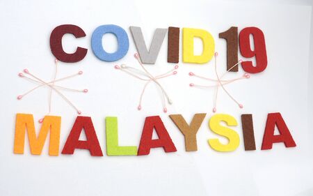CONCEPT COVID-19 PENDAMIC  The coronavirus COVID-19 is affecting 210 countries include Malaysia. White background and some blur effect. Colourful felt Text .の写真素材
