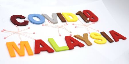 CONCEPT COVID-19 PENDAMIC  The coronavirus COVID-19 is affecting 210 countries include Malaysia. White background and some blur effect. Colourful felt Text .の写真素材