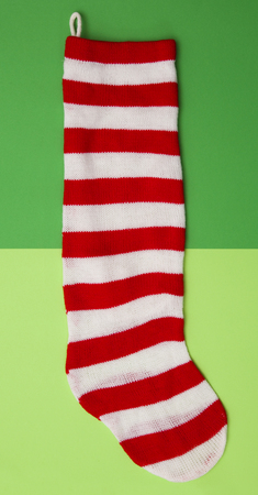 Red and White Striped Stocking on a Duel Greenの写真素材