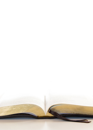 Simple Open Holy Bible on a White Table and a White Background