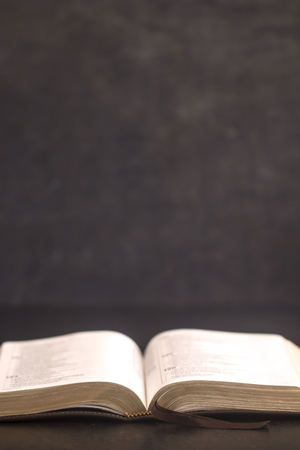 Open Bible on a Slate Tabletop with Customizable Space to Add Textの写真素材