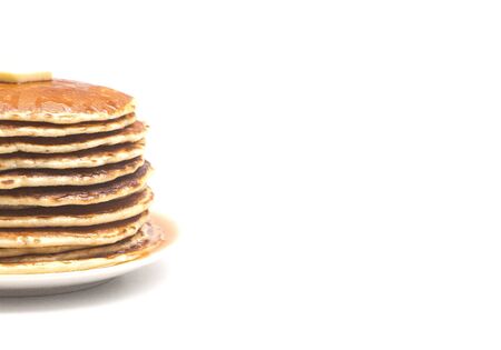 A Stack of Fresh Buttermilk Pancakes with Butter and Syrup on a White Backgroundの写真素材