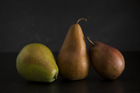 Still LIfe of Fresh Pears on a Dark Surface and Backgroundの写真素材