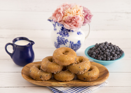 Blueberry Cake Donuts on a White Wooden Tableの写真素材