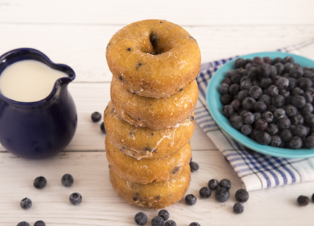 Blueberry Cake Donuts on a White Wooden Tableの写真素材