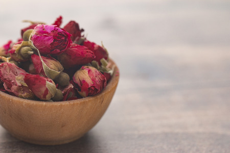Dried Pink Rose Buds in a Brown Bowlの写真素材