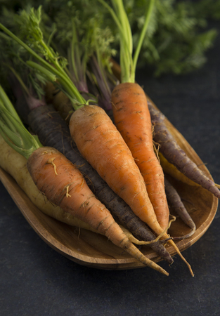 Orange Carrots on a Wooden Platterの写真素材