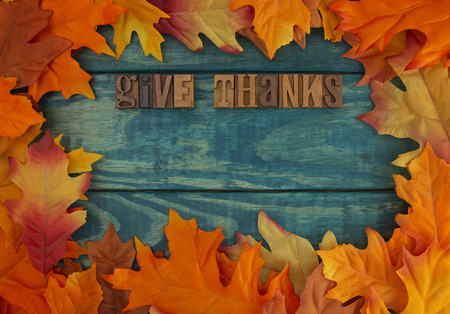 Give Thanks Background with Fall Leaves on Blue Woodの写真素材