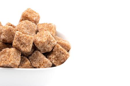 Brown Sugar Cubes on a White Backgroundの写真素材