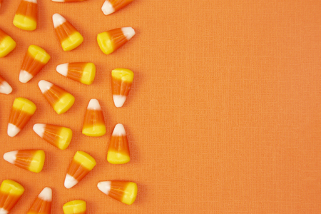 Halloween Candy Background on an Orange Surfaceの写真素材