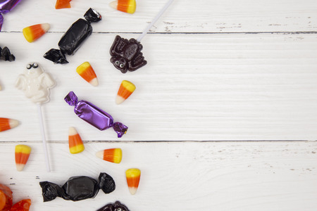 Halloween Candy Background on a White Wood Table