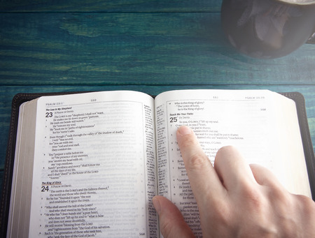 Holy Bible on a Blue Wooden Table Out for Studyingの写真素材