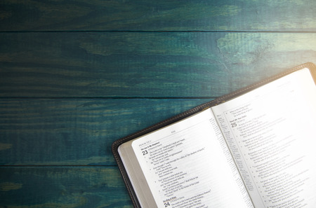 Holy Bible on a Blue Wooden Table Out for Studying