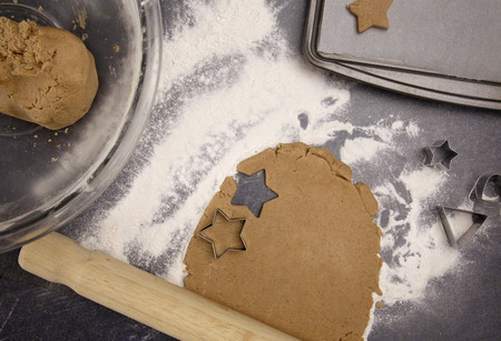 Gingerbread Cookies Being Rolled Out and Cut into Christmas Stars