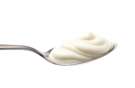 A Spoon Full of Yogurt on a White Backgroundの写真素材
