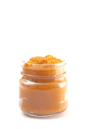 A Glass Canning Jar Filled with Orange Vegetable Pureeの写真素材