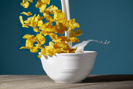 A Bowl of Healthy Corn Flakes with Splashing Milk for Breakfast
