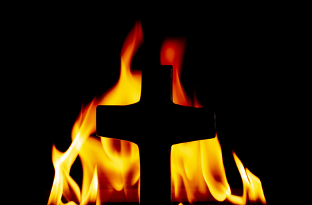 Cross with Fire in the Backgroundの写真素材