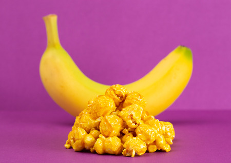 Gourmet Banana Flavored Popcorn on a Purple Backgroundの写真素材