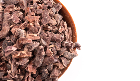 A Bowl of Chocolate Nibs Isolated on a White Backgroundの写真素材