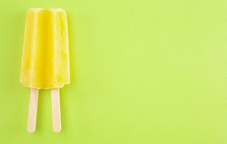 Yellow ice on a Bright Green Backgroundの写真素材