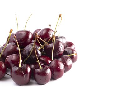 Fresh Dark Red Cherries with Stems Isolated on a White Backgroundの写真素材