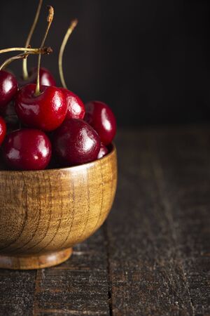 Bowl Full of Dark Red Cherries with Stems Isolated on a White Backgroundの写真素材