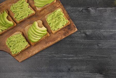 Six Pieces of Avocado Toast on a Wooden Tableの写真素材