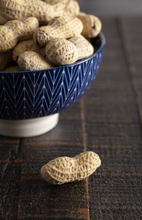 Raw In Shell Peanuts on a Rustic Wooden Kitchen Table