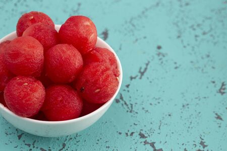 Juicy Watermelon Balls on a Teal Distressed Surfaceの写真素材