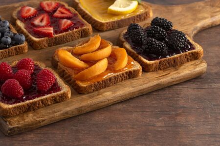 Six Pieces of Fruit Toast on a Wooden Cutting Board