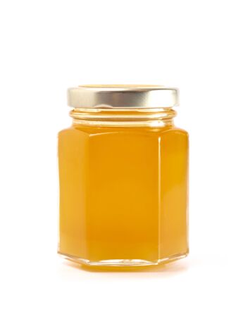 A Jar of Raw Natural Honey Isolated on a White Backgroundの写真素材
