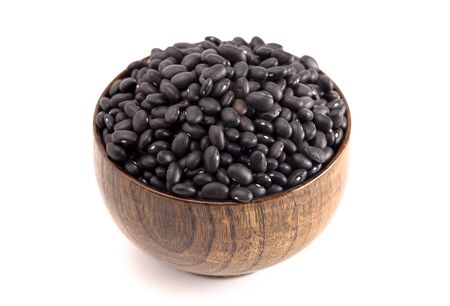 A Bowl of Dry Black Beans Isolated on a White Backgroundの写真素材