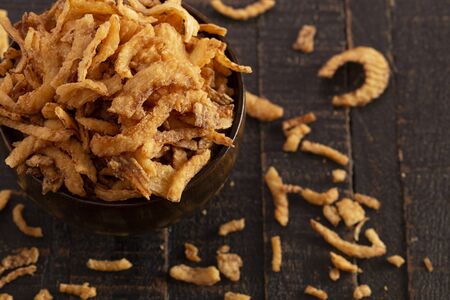 Fried Onions for Green Bean Casserole or Salad Garnish on a Rustic Wooden Tableの写真素材