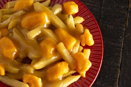 Poutine with Orange Cheddar Cheese with Brown Gravy on French Fries