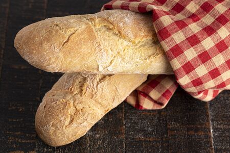 Two Loaves of Fresh French Baguette on a Rustic Wooden Table
