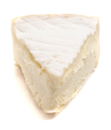 Triangle Slice of a Soft White Cheese with a Rine Isolated on a  White Backgroundの写真素材